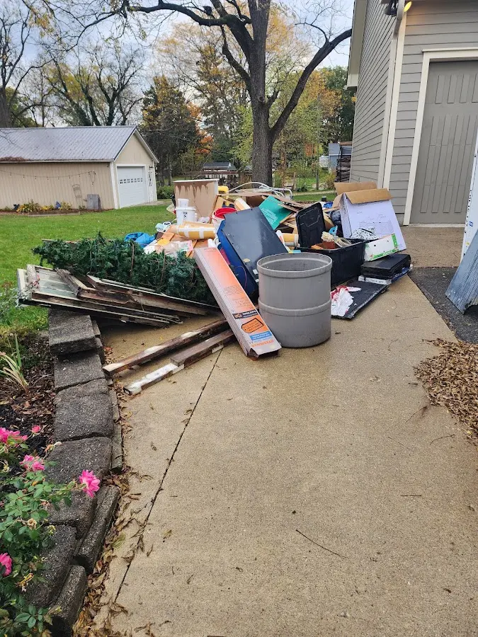 Dumpster being loaded with debris for Roofing Dumpster Rental in Palmer